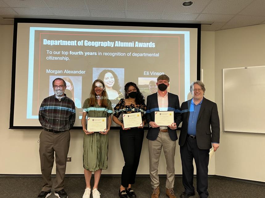 Morgan Alexander (center left), Rachael Glenn (centermost), and Eli Vinson (center right) receive the Alumni Award