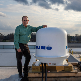 GTU Professor poses with the new weather radar