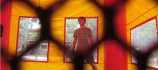 Student stands in a UGA themed bounce house