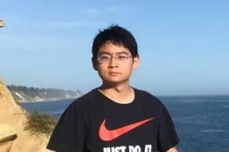 Dr. Gengchen Mai poses near the ocean 