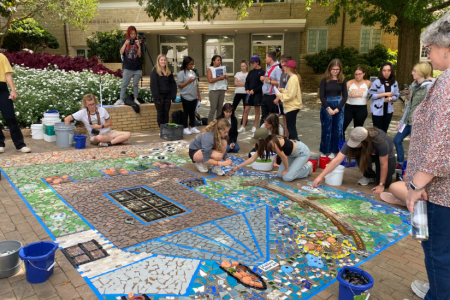 Students contribute to a temporary mosaic installation