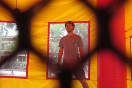 Student stands in a UGA themed bounce house